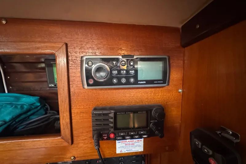 Slide: The Image of Control panel inside 1985 Beneteau First 38 sailboat, featuring radio and navigation equipment. - 35