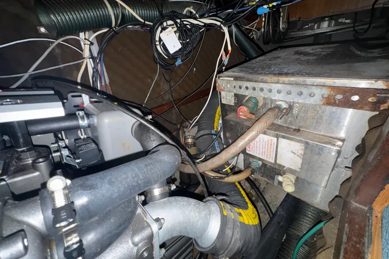 Slide: The Image of Engine compartment of a 1985 Beneteau First 38 sailboat, showing wiring and components. - 39