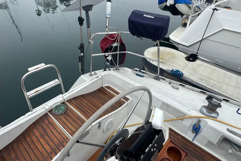 Slide: The Image of Cockpit of a 1985 Beneteau First 38 sailboat with wooden flooring and steering wheel. - 4