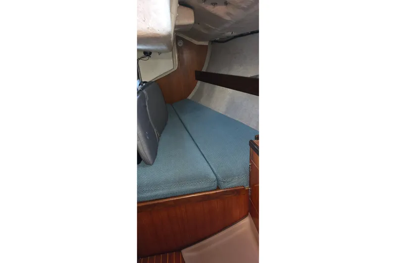 Slide: The Image of Interior cabin of 1985 Beneteau First 38 sailboat with blue cushions. - 40