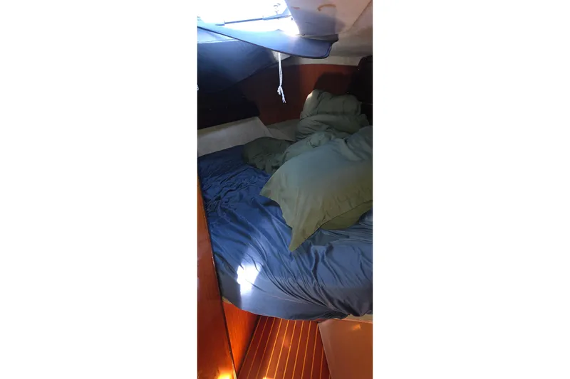 Slide: The Image of Cozy cabin interior of 1985 Beneteau First 38 sailboat with blue bedding. - 42