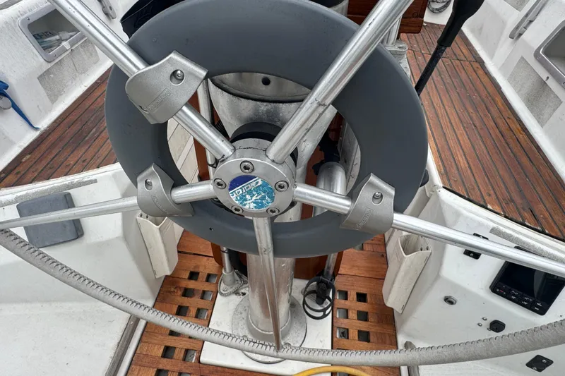 Slide: The Image of Steering wheel of 1985 Beneteau First 38 sailboat with wooden deck details. - 7