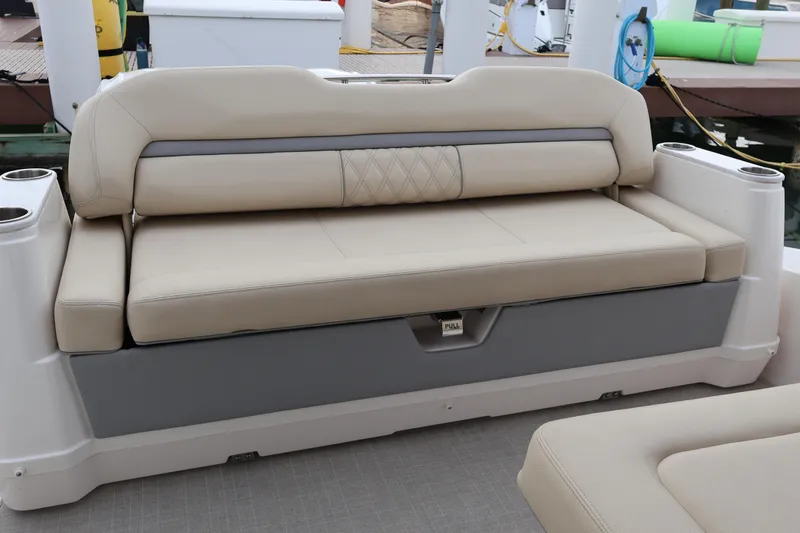Slide: The Image of Beige seating on 2022 Regal 36 XO boat, docked with cup holders. - 15