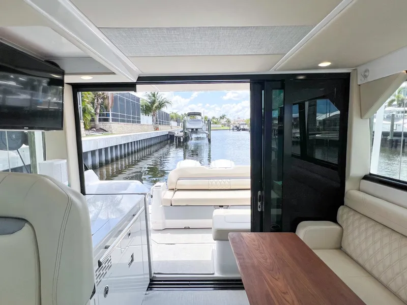 Slide: The Image of Interior view of 2022 Regal 36 XO yacht with waterfront backdrop. - 21