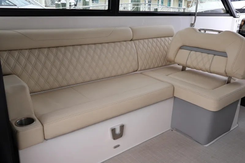 Slide: The Image of Interior of a 2022 Regal 36 XO yacht with luxurious seating and modern helm. - 24