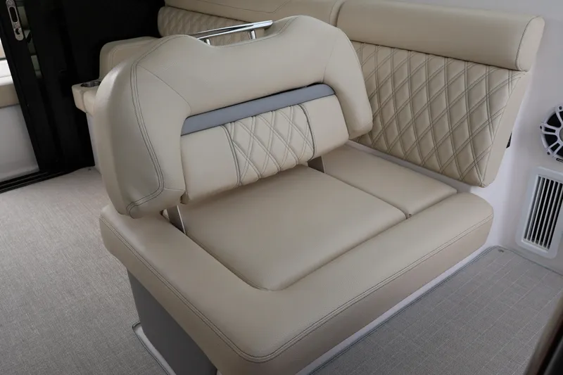 Slide: The Image of Luxurious beige seating on 2022 Regal 36 XO boat, featuring diamond stitching and integrated cup holder. - 25