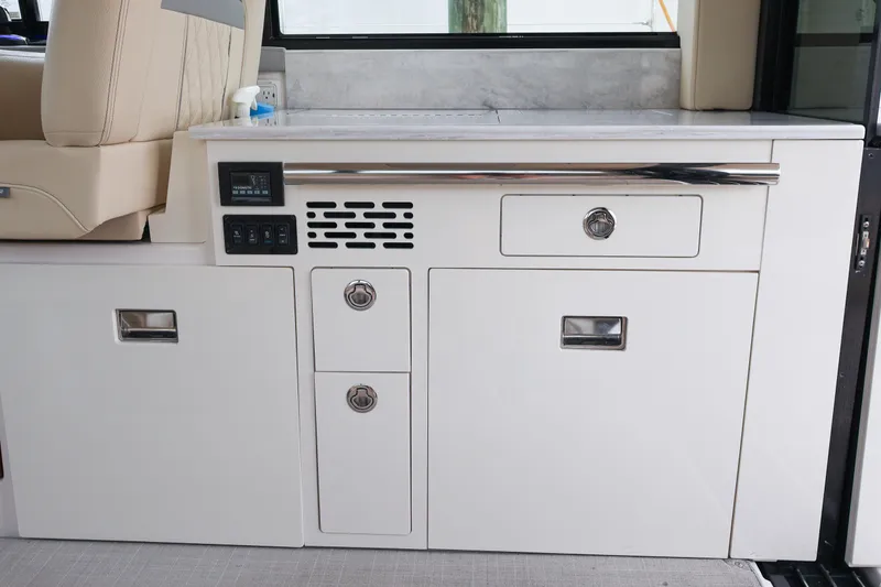 Slide: The Image of White Fusion speaker on 2022 Regal 36 XO boat, featuring blue LED lighting. - 29