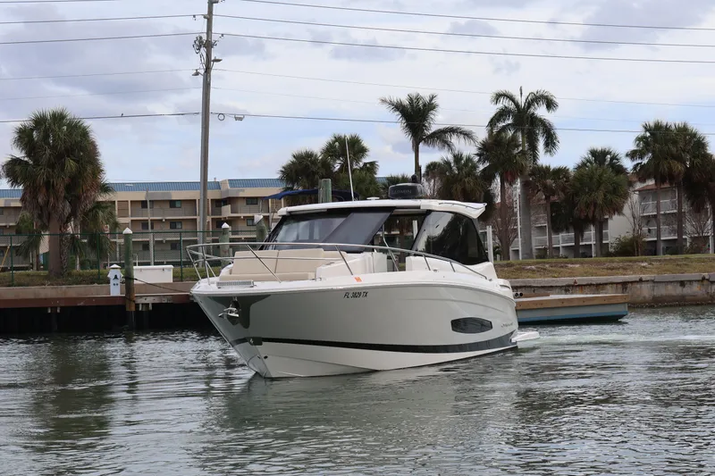 Slide: The Image of 2022 Regal 36 XO boat docked in marina, showcasing sleek design and modern features. - 3