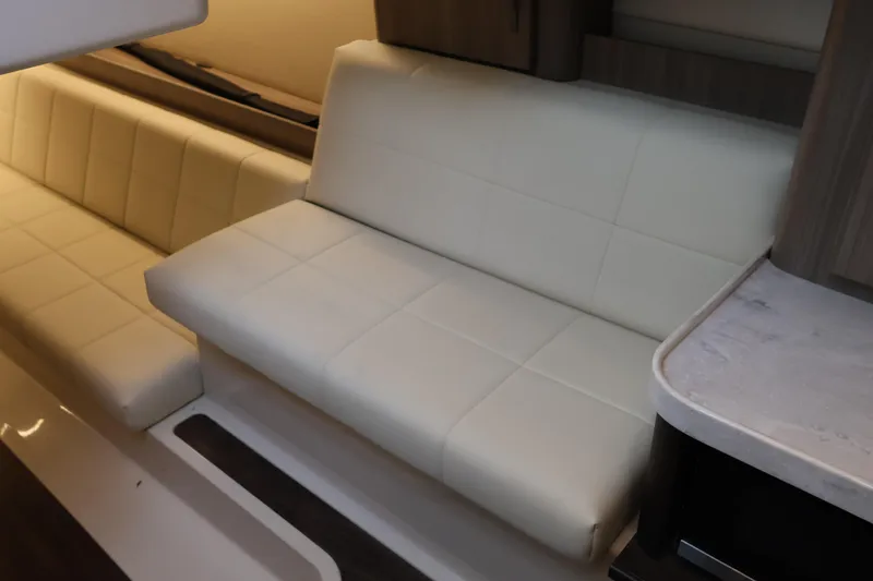Slide: The Image of Luxurious interior seating of 2022 Regal 36 XO yacht with cream upholstery. - 50