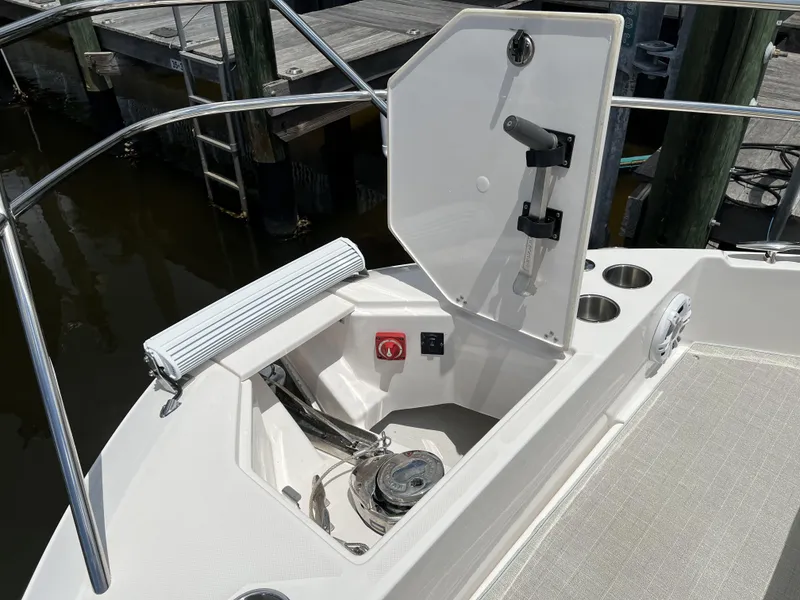 Slide: The Image of 2022 Regal 36 XO boat deck with storage compartment and cup holders. - 64