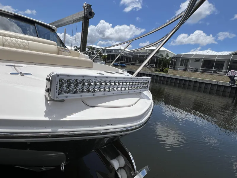 Slide: The Image of 2022 Regal 36 XO boat with open storage compartment and cup holders. - 66