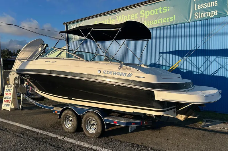 The Image of 2003 Four Winns 225 Sundowner boat on trailer at sales location. - 1