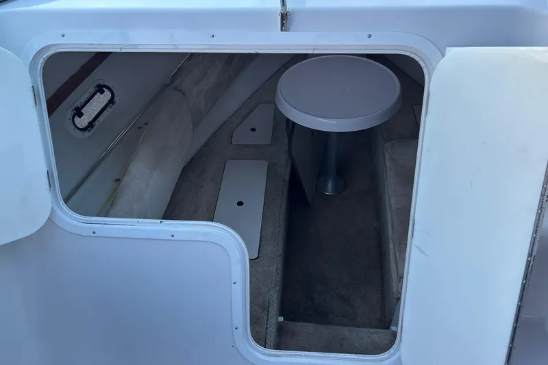 Slide: The Image of 2003 Four Winns 225 Sundowner cabin interior with seating and table. - 10