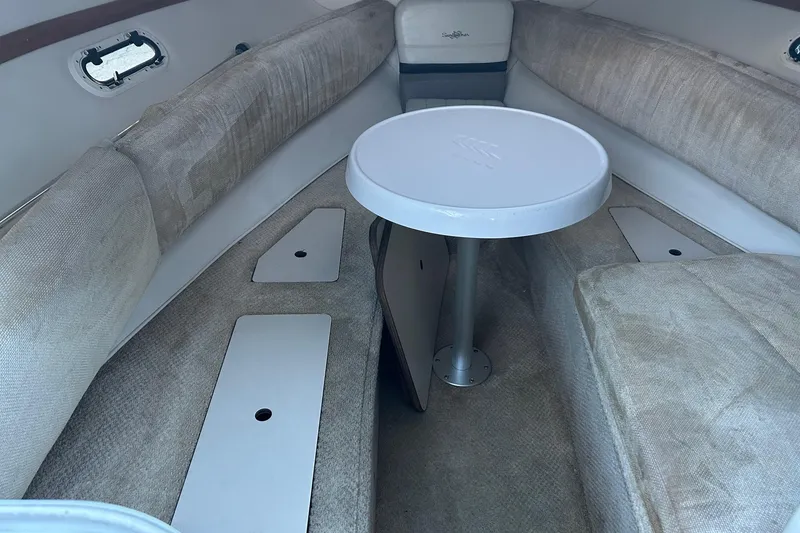 Slide: The Image of 2003 Four Winns 225 Sundowner cabin interior with table and seating. - 11