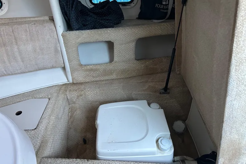 Slide: The Image of Interior of 2003 Four Winns 225 Sundowner boat with portable toilet. - 12