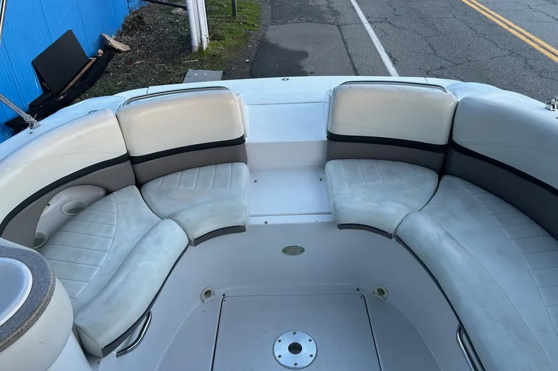 Slide: The Image of 2003 Four Winns 225 Sundowner boat interior with white cushioned seating. - 13