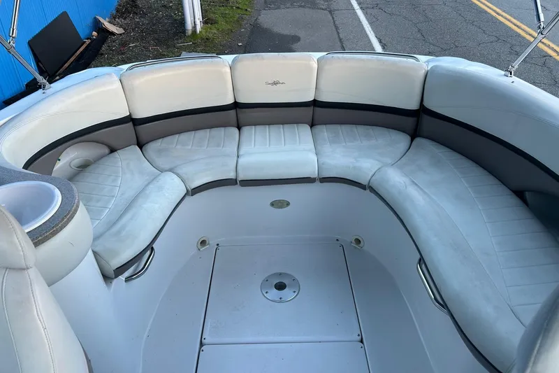 Slide: The Image of 2003 Four Winns 225 Sundowner boat interior with curved seating and cup holder. - 14
