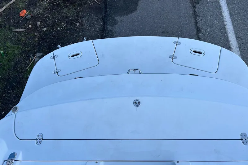 Slide: The Image of 2003 Four Winns 225 Sundowner boat deck, white surface with storage compartments. - 19