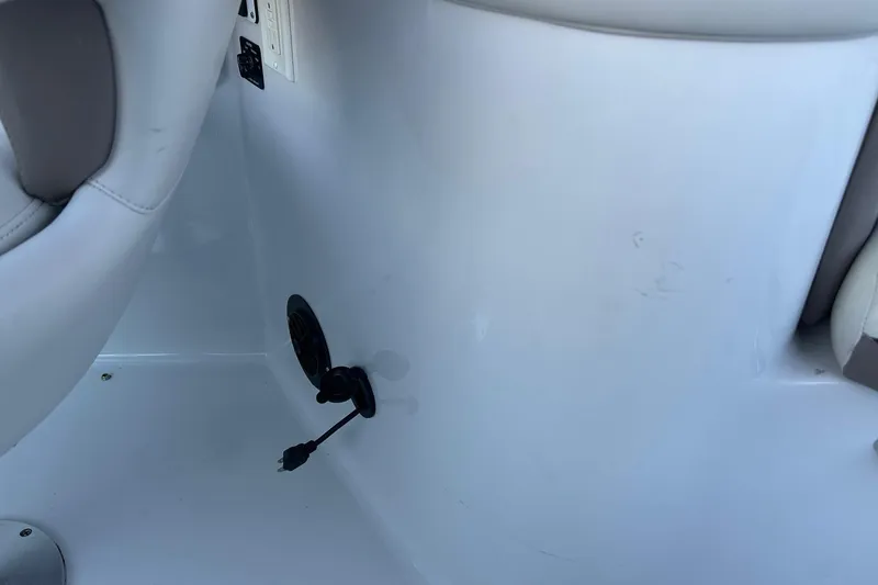 Slide: The Image of Interior view of a 2003 Four Winns 225 Sundowner boat, featuring a steering wheel and control panel. - 20