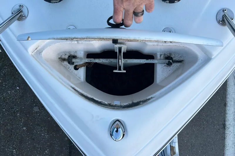 Slide: The Image of 2003 Four Winns 225 Sundowner anchor compartment with hand opening hatch. - 22