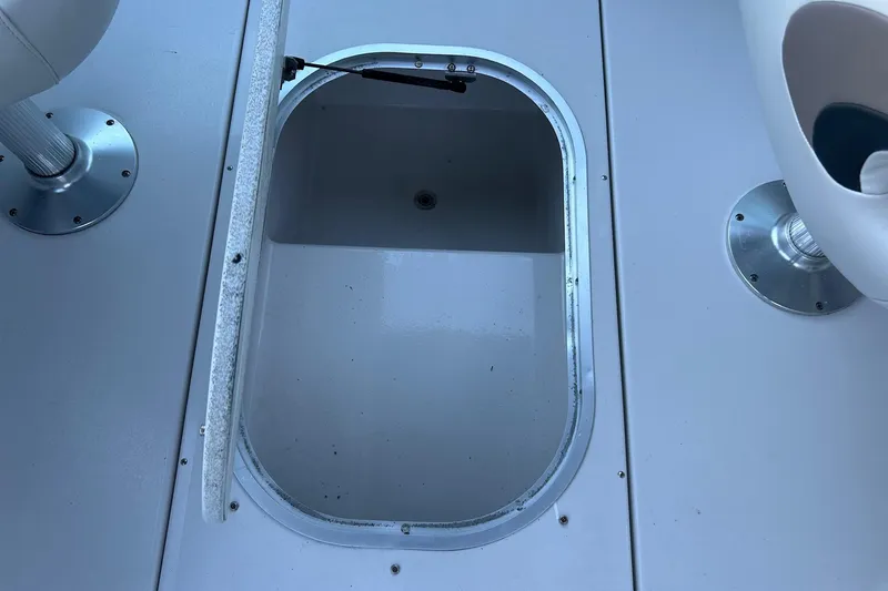 Slide: The Image of Open storage compartment on 2003 Four Winns 225 Sundowner boat deck. - 24