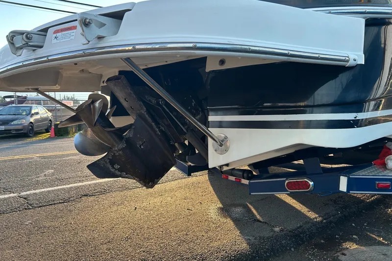 Slide: The Image of 2003 Four Winns 225 Sundowner boat stern with propeller on trailer. - 4