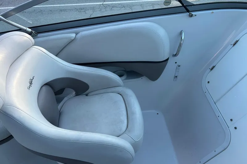 Slide: The Image of 2003 Four Winns 225 Sundowner boat interior with white seating and sleek design. - 9