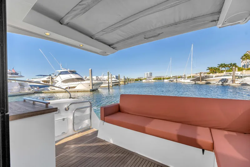 Slide: The Image of 2020 Sealine C390 yacht interior with marina view, featuring a comfortable seating area. - 21