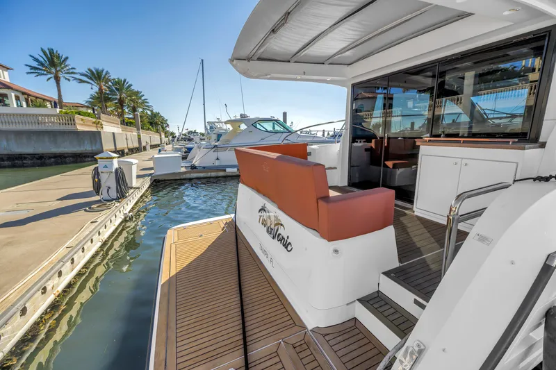 Slide: The Image of 2020 Sealine C390 yacht docked at marina with palm trees and clear sky. - 24