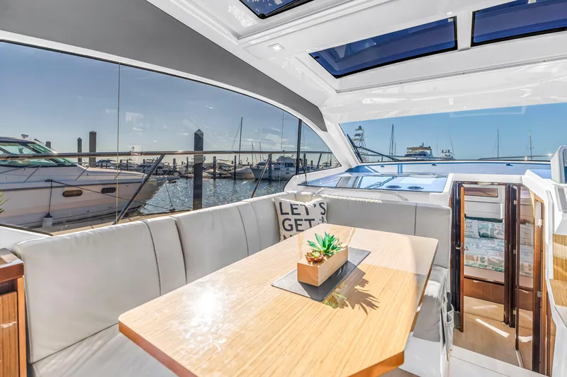 Slide: The Image of Interior of 2020 Sealine C390 yacht with dining area and marina view. - 31
