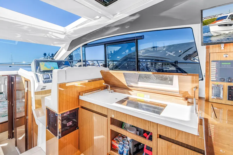 Slide: The Image of Interior of 2020 Sealine C390 yacht with modern navigation and kitchen area. - 35