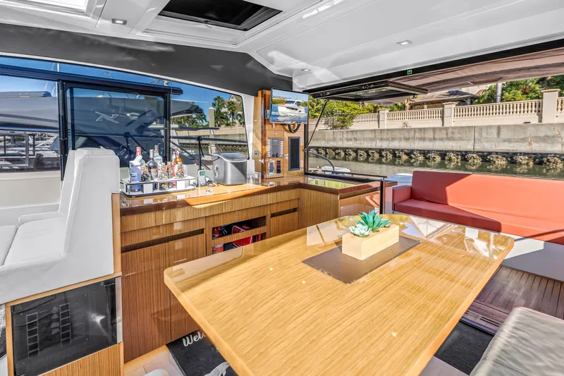 Slide: The Image of Luxurious interior of 2020 Sealine C390 yacht with modern seating and elegant wooden table. - 38