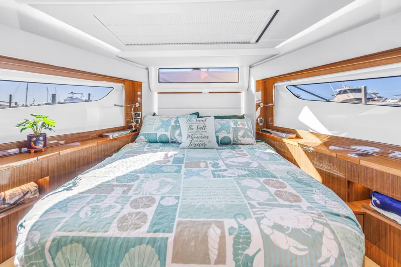 Slide: The Image of Luxurious bedroom interior of 2020 Sealine C390 yacht with nautical decor and panoramic windows. - 43