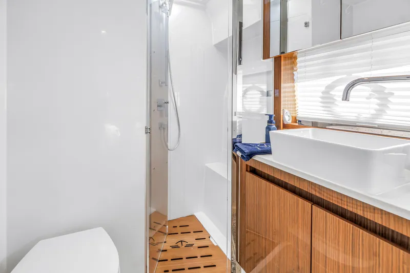 Slide: The Image of Luxurious bathroom in 2020 Sealine C390 yacht with modern fixtures and wooden accents. - 47