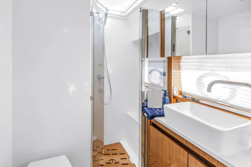 Slide: The Image of Modern bathroom in 2020 Sealine C390 yacht with sleek fixtures and wooden accents. - 48