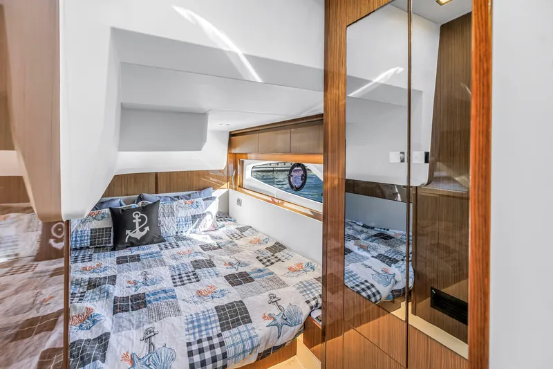 Slide: The Image of Luxurious cabin interior of 2020 Sealine C390 yacht with nautical-themed bedding. - 50