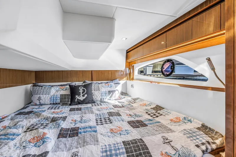 Slide: The Image of Luxurious cabin interior of 2020 Sealine C390 yacht with nautical-themed bedding. - 51