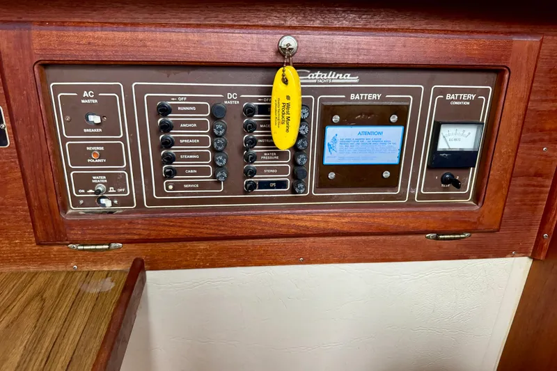 Slide: The Image of Electrical control panel of a 1986 Catalina 36 yacht with AC and DC switches. - 12