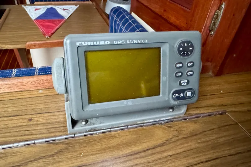 Slide: The Image of Furuno GPS Navigator on 1986 Catalina 36 sailboat interior, wooden table, nautical decor. - 13