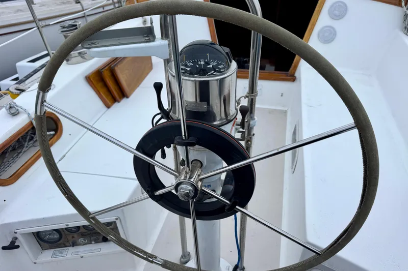 Slide: The Image of Steering wheel of a 1986 Catalina 36 sailboat with compass and cockpit view. - 14