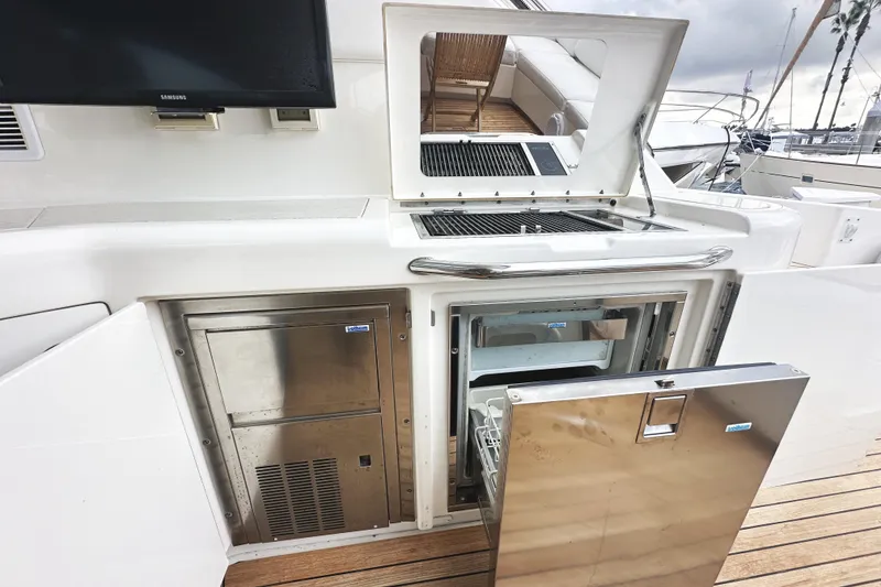 Slide: The Image of Outdoor kitchen on 2010 Sea Ray Sundancer 540 yacht with grill and stainless steel appliances. - 16