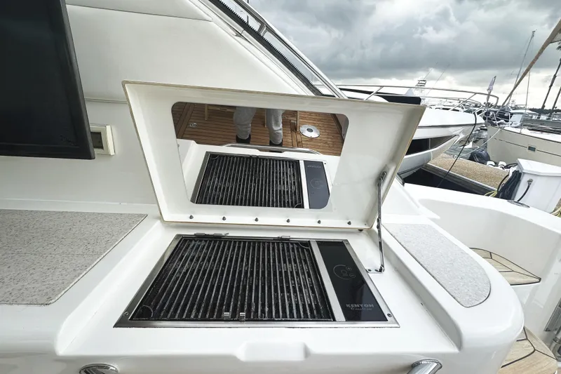 Slide: The Image of Outdoor grill on 2010 Sea Ray Sundancer 540 yacht, docked with cloudy skies. - 17