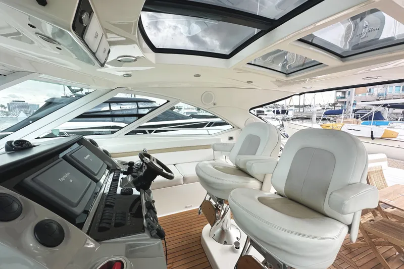 Slide: The Image of Luxurious 2010 Sea Ray Sundancer 540 yacht cockpit with plush seating and modern controls. - 21