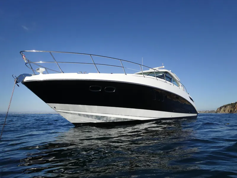 Slide: The Image of 2010 Sea Ray Sundancer 540 yacht on open water under clear blue sky. - 3