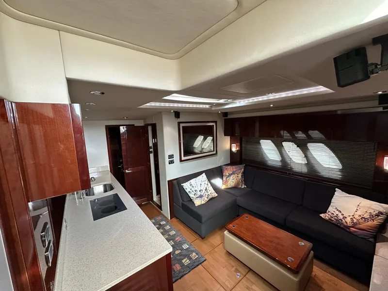 Slide: The Image of Luxurious interior of 2010 Sea Ray Sundancer 540 yacht with modern kitchen and cozy seating area. - 30