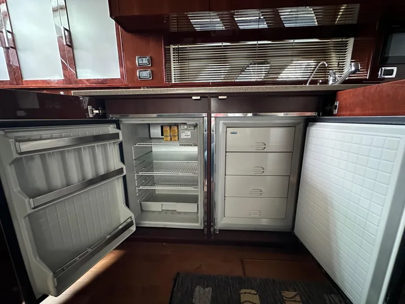 Slide: The Image of 2010 Sea Ray Sundancer 540 yacht kitchen with open fridge and freezer - 34