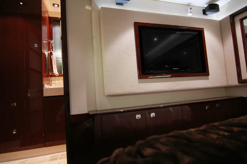 Slide: The Image of Luxurious interior of 2010 Sea Ray Sundancer 540 with mounted TV and wooden cabinetry. - 36