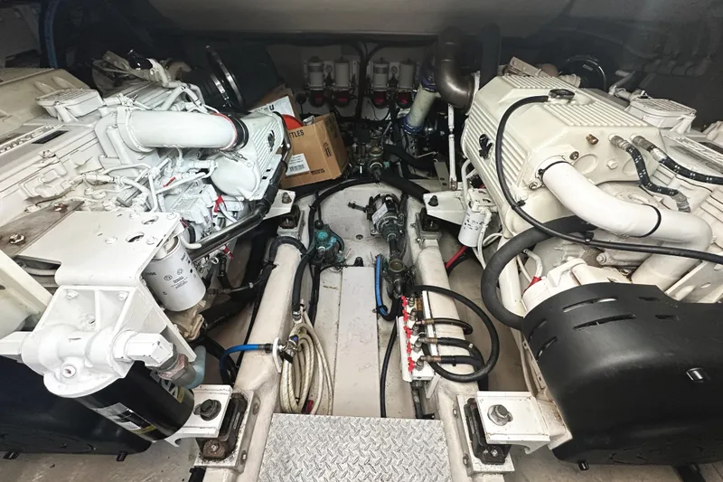 Slide: The Image of Engine room of a 2010 Sea Ray Sundancer 540 yacht, showcasing dual engines and mechanical components. - 43