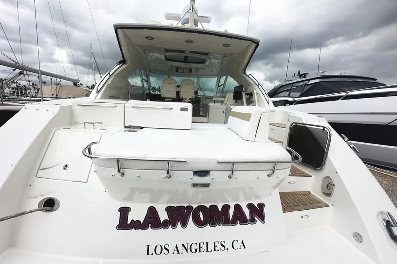 Slide: The Image of 2010 Sea Ray Sundancer 540 yacht docked, featuring spacious deck and seating, labeled "L.A. Woman." - 6