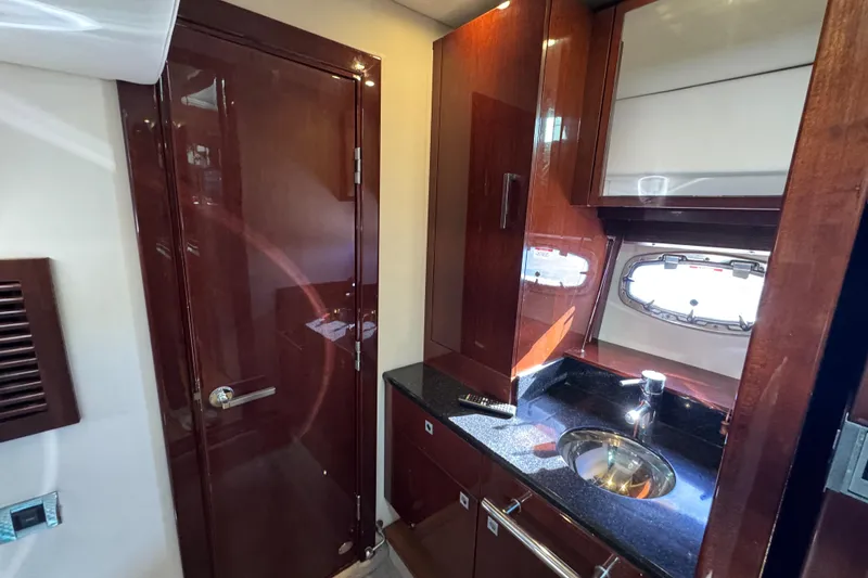 Slide: The Image of Luxurious interior of 2010 Sea Ray 470 Sundancer yacht with white seating and table. - 11